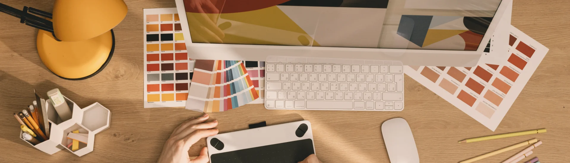 Designer at tablet with color swatches — Common Name course, marketing and behavior