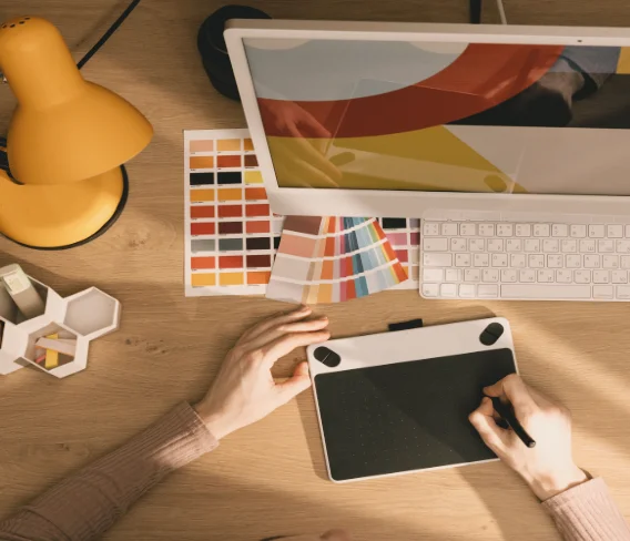 Designer at tablet with color swatches — Common Name course, marketing and behavior