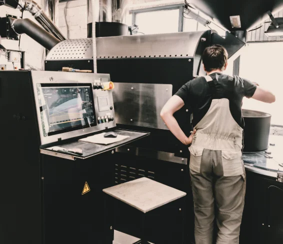 Coffee roaster at roasting machine with monitor — The Profile course, roasting and brewing